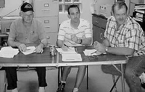 RILED UP — Pocahontas County Public Service District board members Chairman William Rexrode, Scott Millican and Mark Smith listen to comments about the Slatyfork sewage plant.